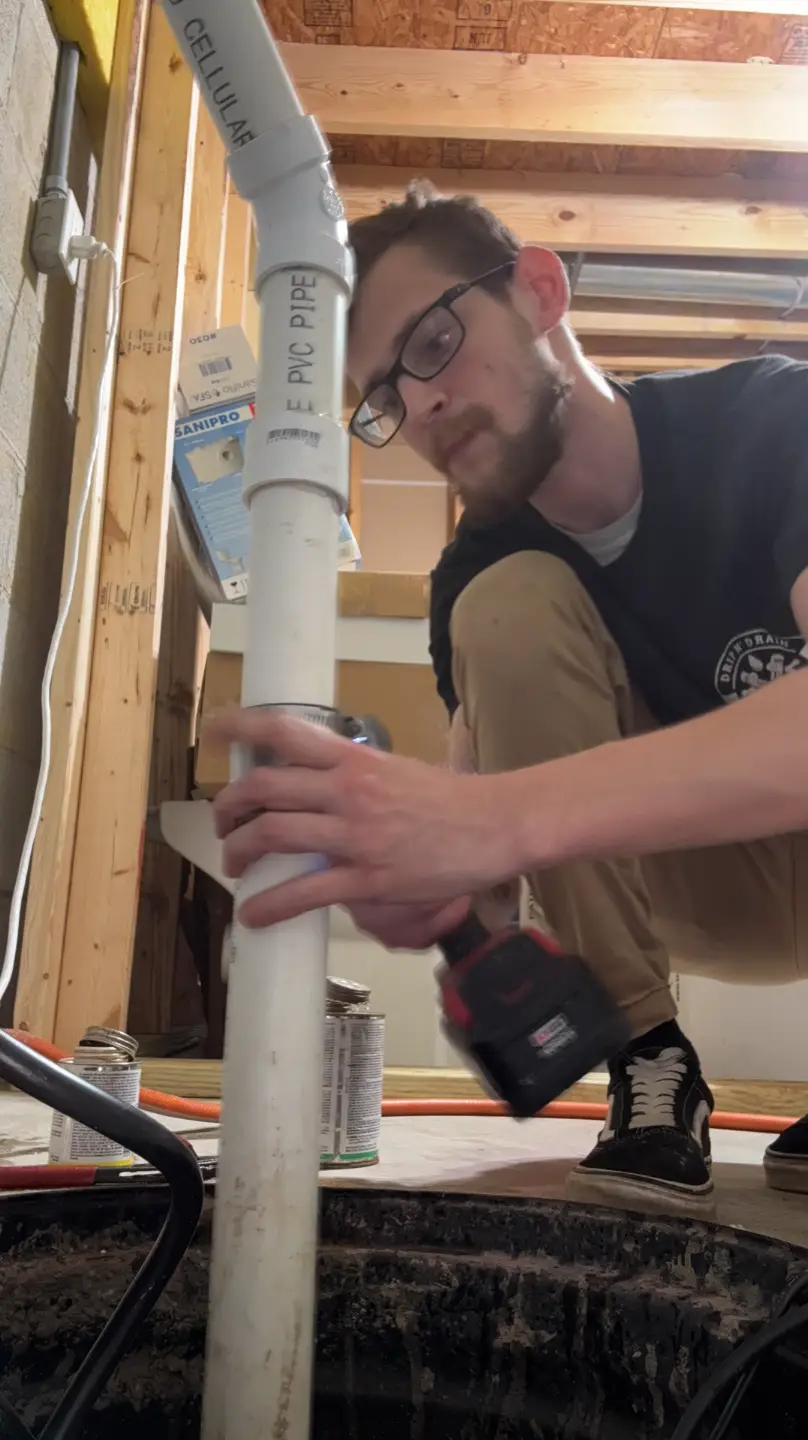 Drip N Drain plumber working on a PVC pipe repair in Hebron, Ohio