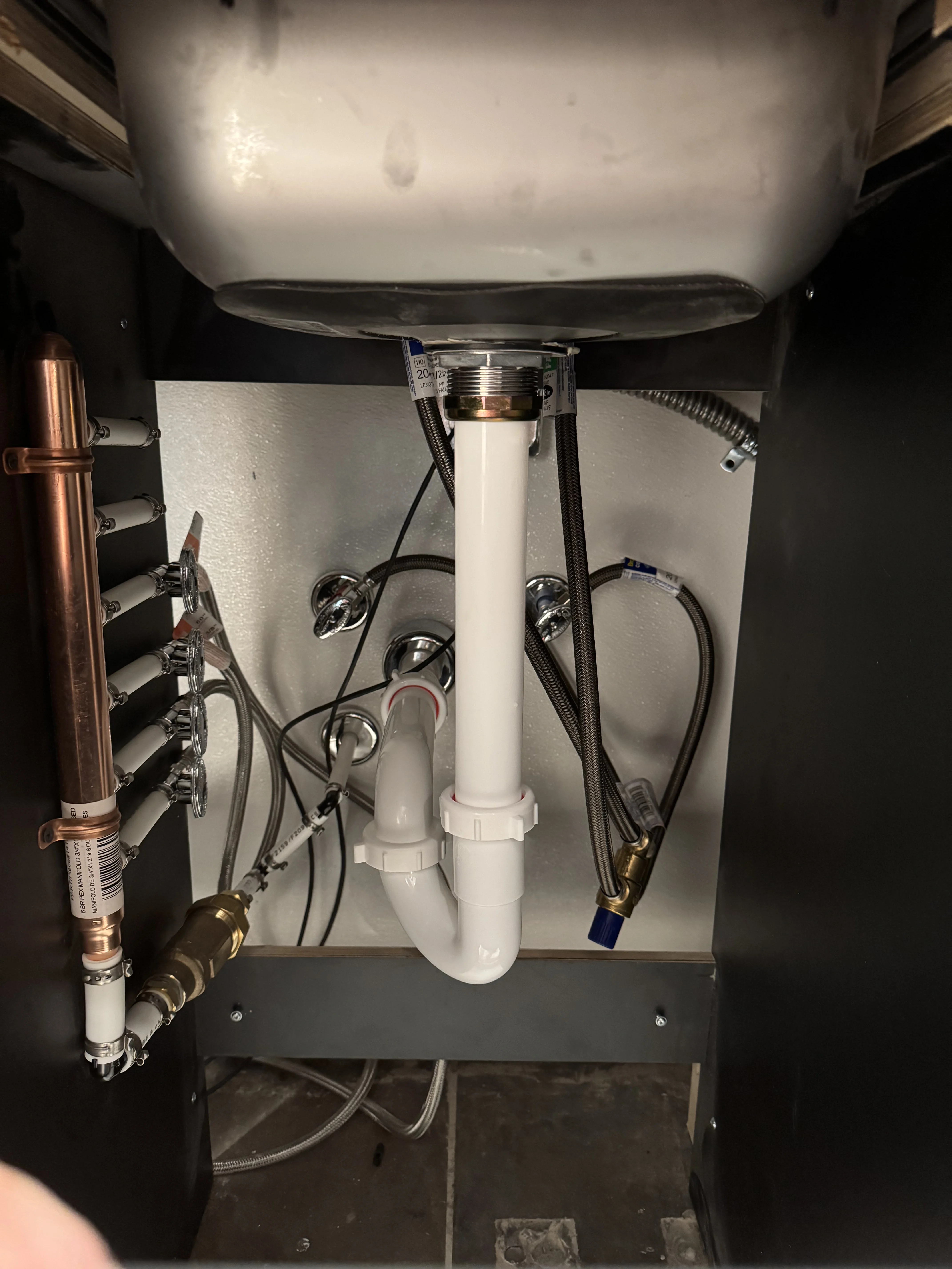 Under-sink drain trap and supply lines connected to a new PEX manifold
