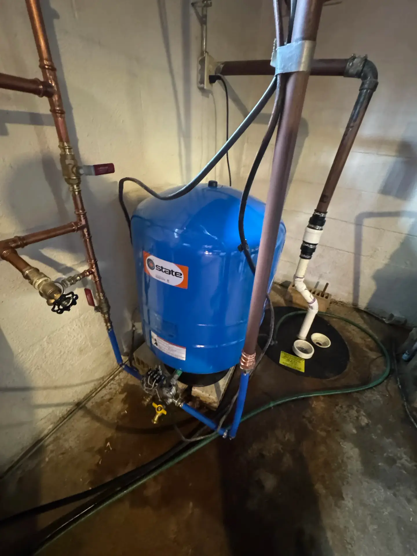 Well water pressure tank plumbed into a home's supply lines